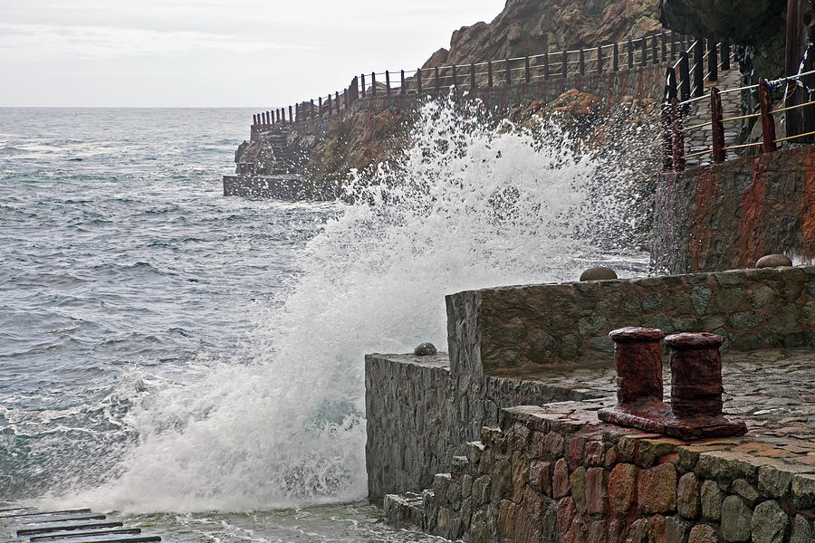A Wave Crashing Into A Stone Wall On Photograph by John Doornkamp / Design Pics