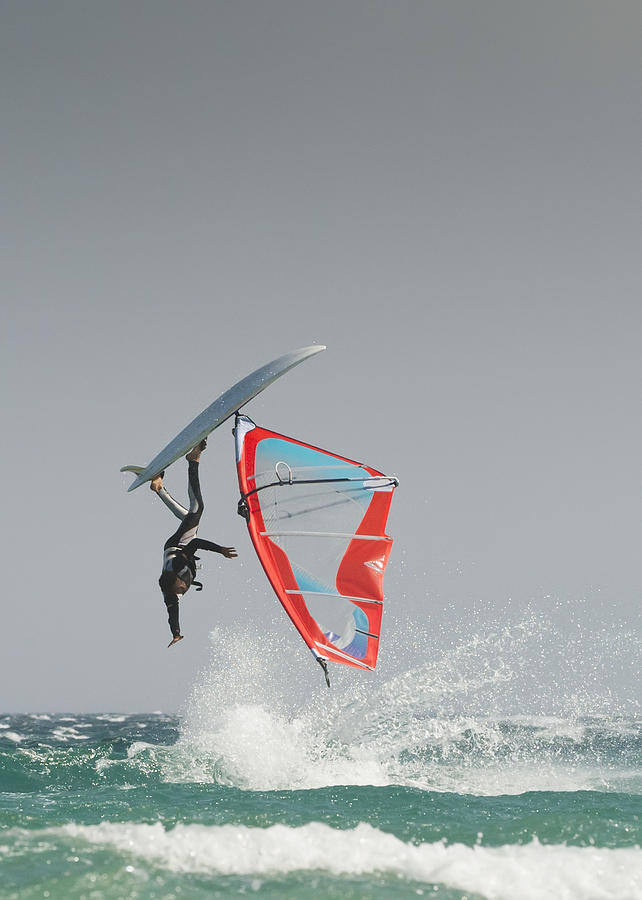 Daredevil Photograph - A Windsurfer Flips Upside Down On The by Ben Welsh