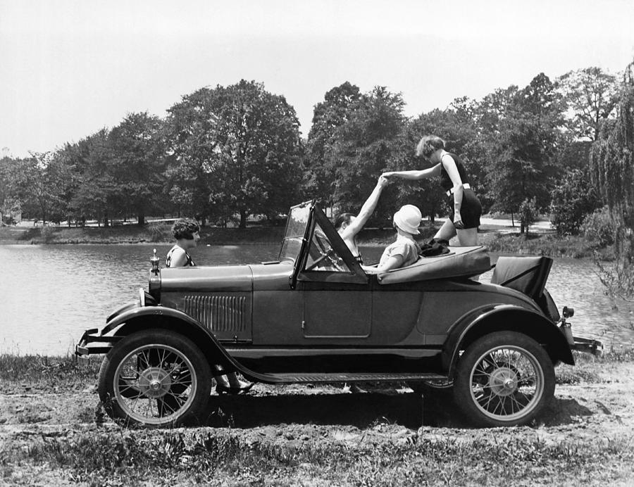 A Woman Exiting A Rumble Seat Photograph by Underwood Archives