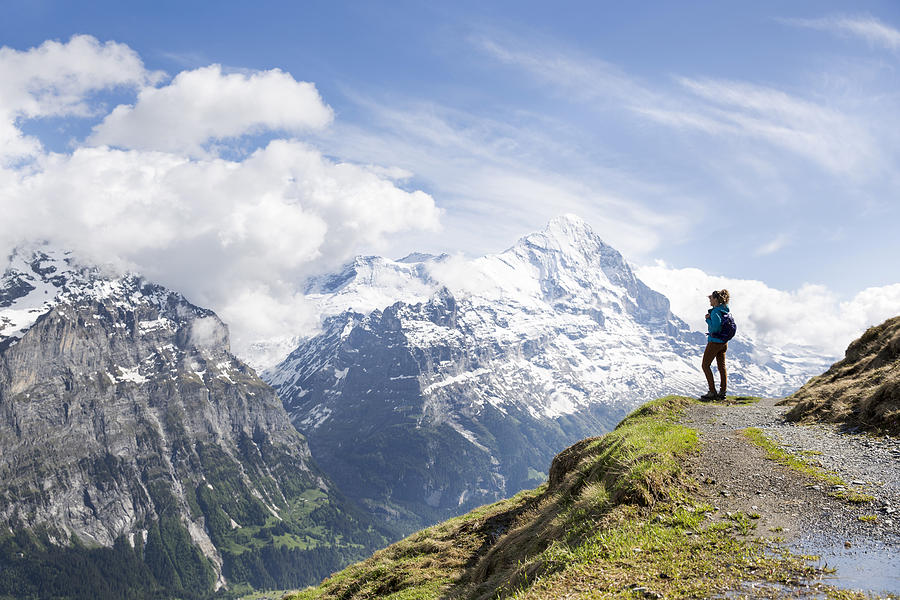 A woman hiking in the Swiss Alps Photograph by Jordan Siemens