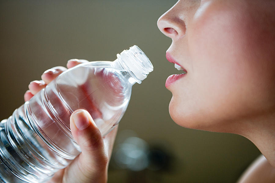 A woman holding a bottle of water Photograph by Image Source