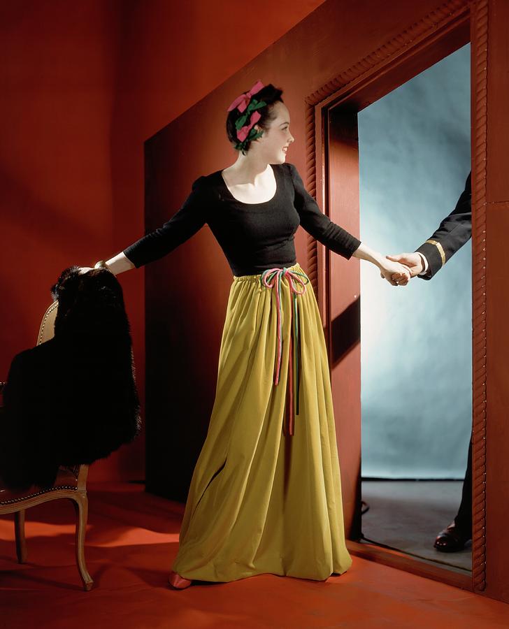 A Woman Holding The Hand Of A Man By A Doorway Photograph by Horst P. Horst