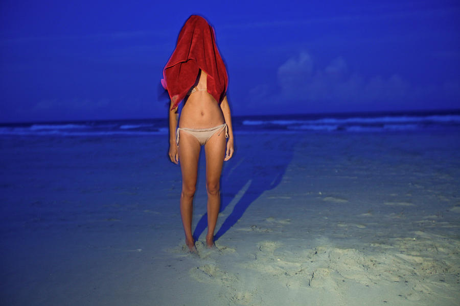 Nature Photograph - A Woman In A Bikini Has A Red Towel by Eyeconic Images