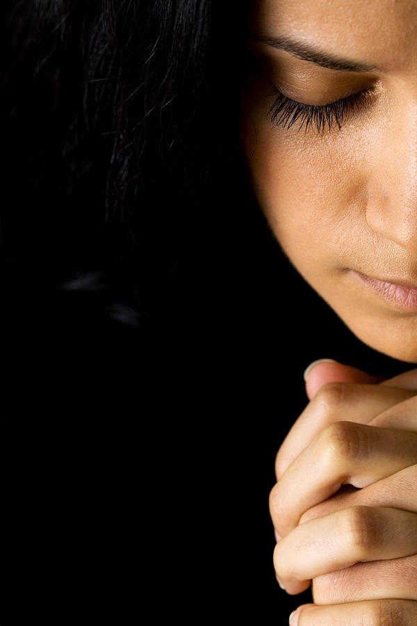 A woman in prayer and a black background Photograph by Artpipi
