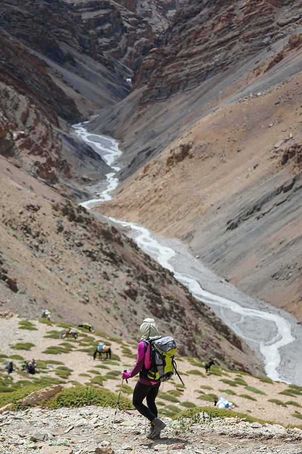 Nature Photograph - A Woman Is Hiking Toward A River by Andrew Peacock