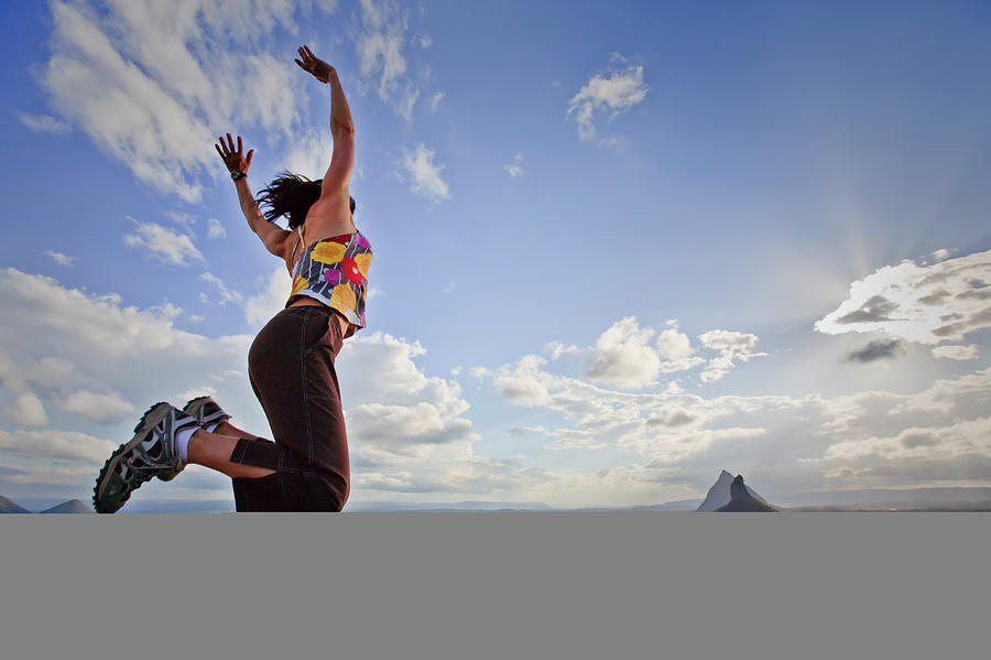 A Woman Jumps In Exuberance Photograph by Andrew Peacock - Fine Art America