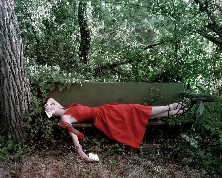 A Woman Lying On A Bench Photograph by John Rawlings