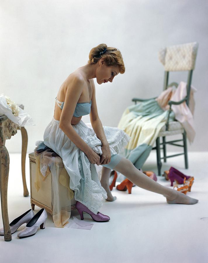 A Woman Putting On Her Stockings Photograph by John Rawlings
