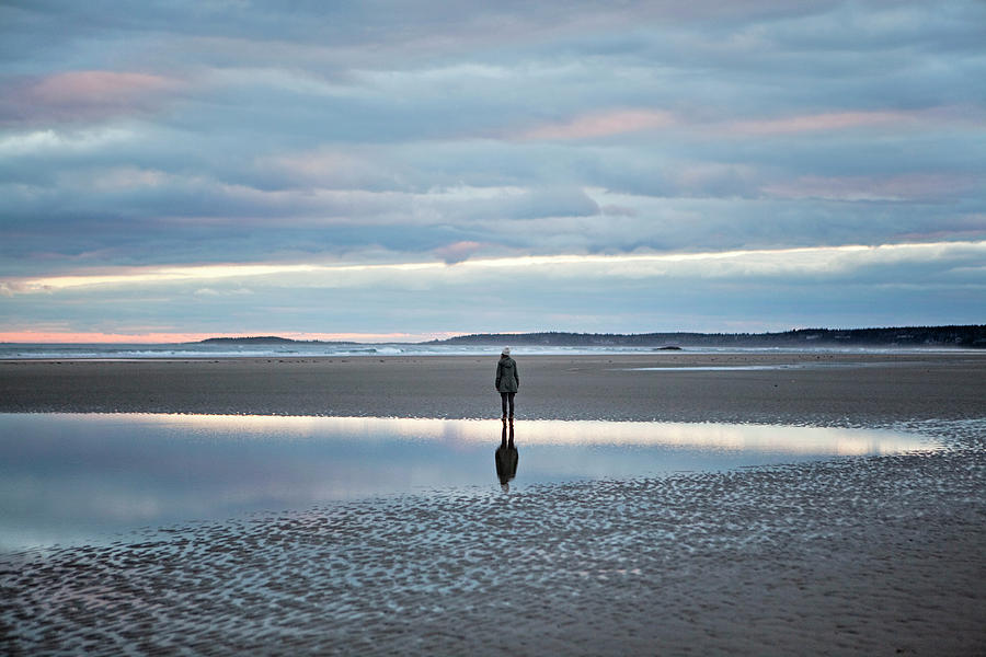 Nature Photograph - A Woman Stands Reflected In A Tidal by Chris Bennett