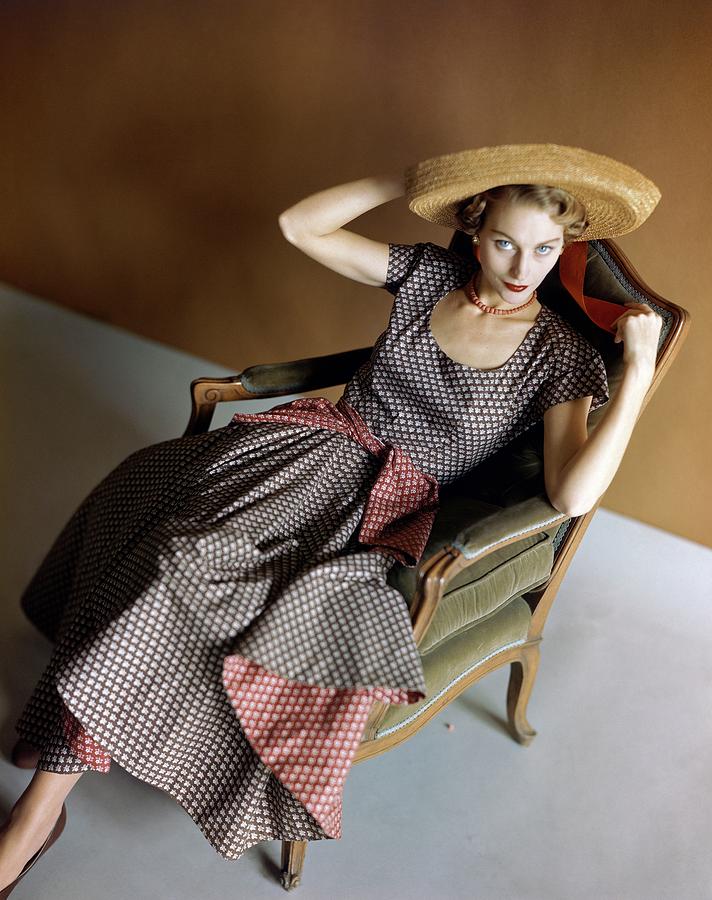 A Woman Wearing A Patterned Dress Sitting In An Photograph by Horst P. Horst