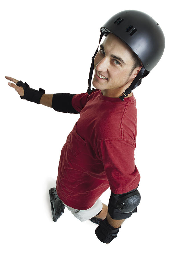 A Young Caucasian Male In A Red Shirt And A Black Helmet Rollerbaldes Forward As He Looks Up At The Camera Photograph by Photodisc