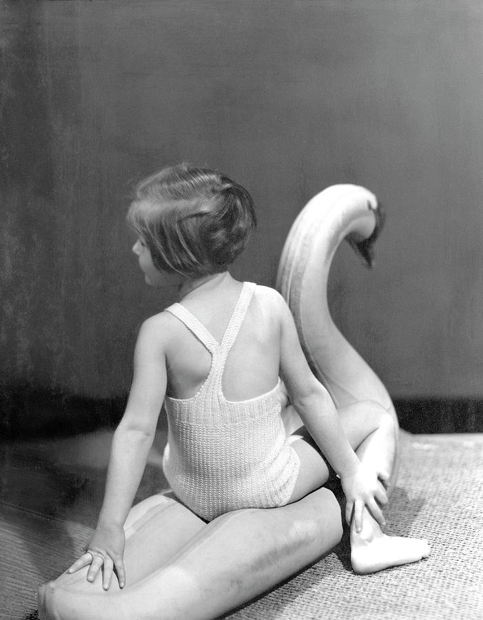A Young Girl Sitting On A Toy Swan Photograph by Horst P. Horst