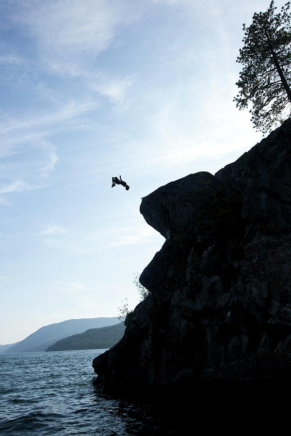 Tree Photograph - A Young Man Flips Off A Rock by Patrick Orton