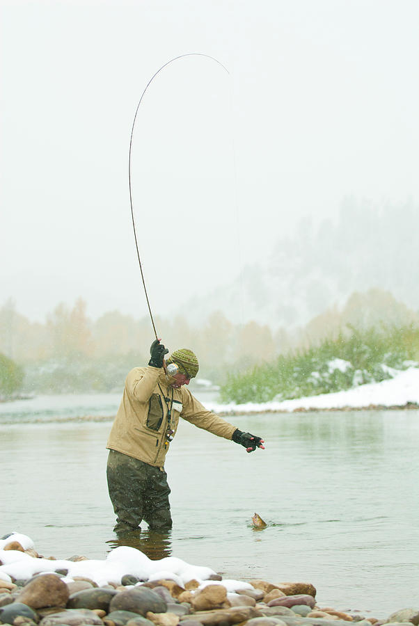 Fish Photograph - A Young Man Fly Fishes In The Gros by Jeff Diener