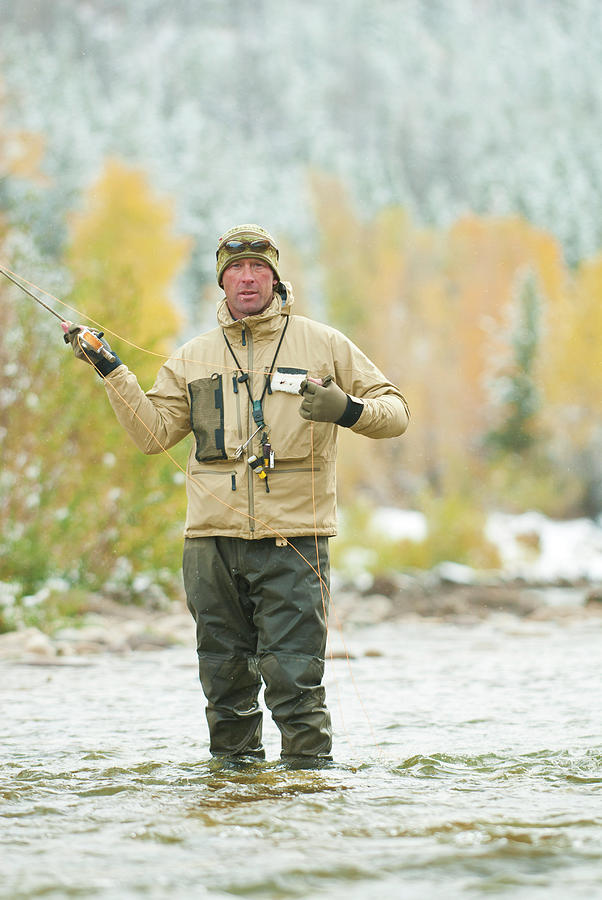 Sports Photograph - A Young Man Fly Fishes The Gros Ventre by Jeff Diener