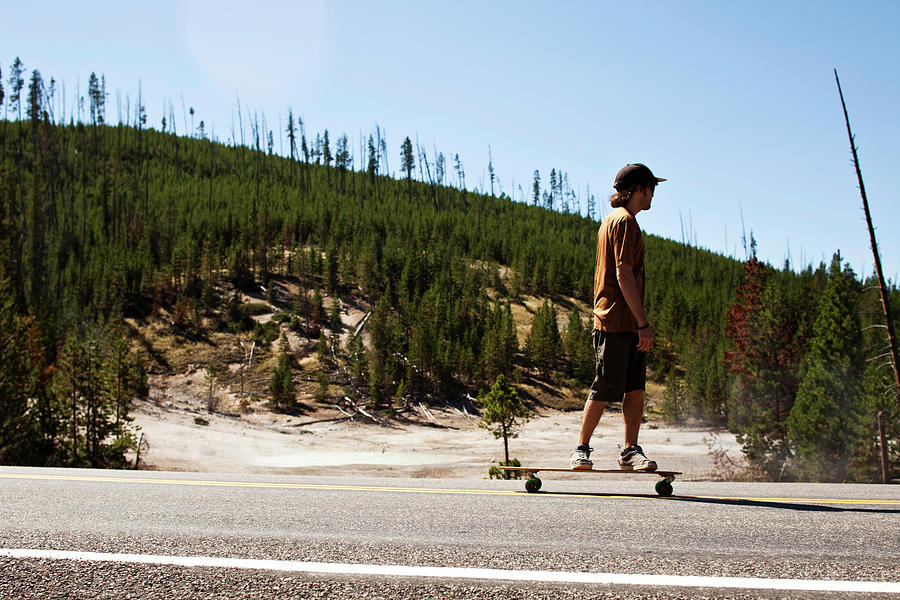 Yellowstone National Park Photograph - A Young Man Longboarding In A National by Patrick Orton
