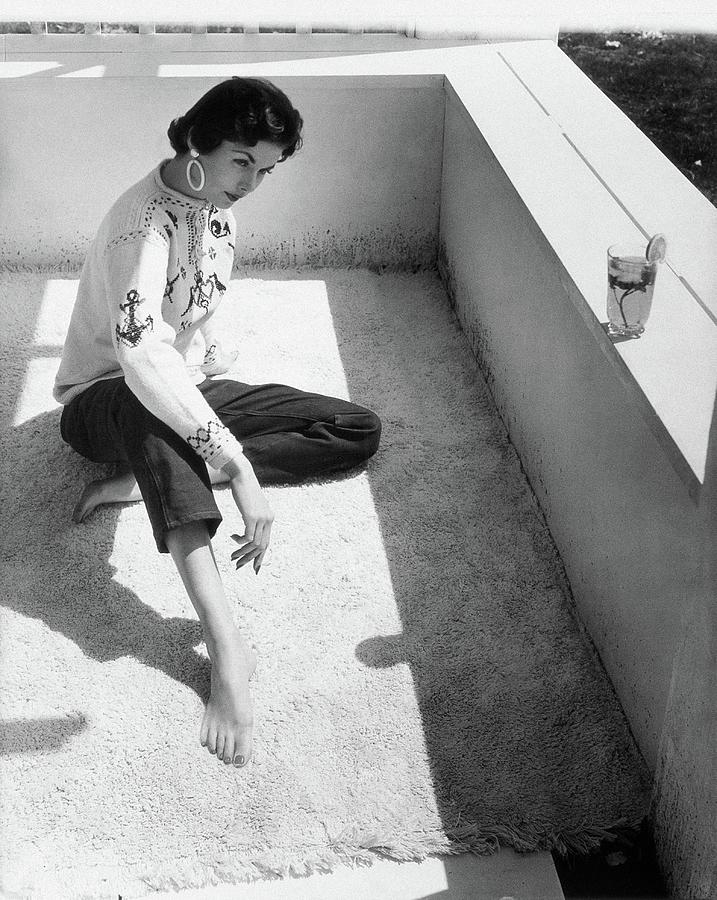 A Young Model Crouching On A Porch Photograph by Horst P. Horst