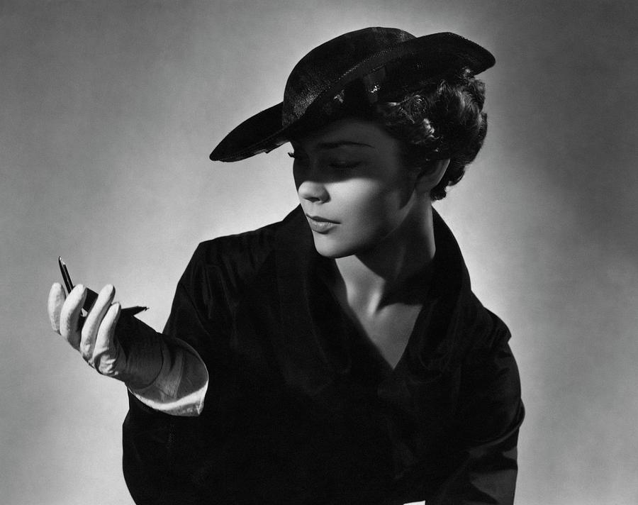 A Young Model Wearing A Black Hat And Holding Photograph by Horst P. Horst