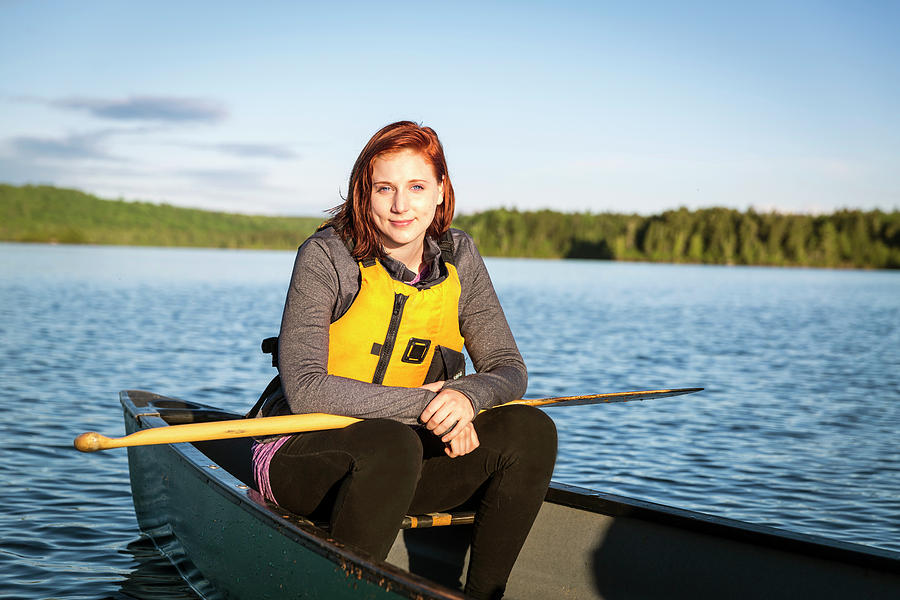 Nature Photograph - A Young Smiling Woman In A Canoe by Jerry Monkman