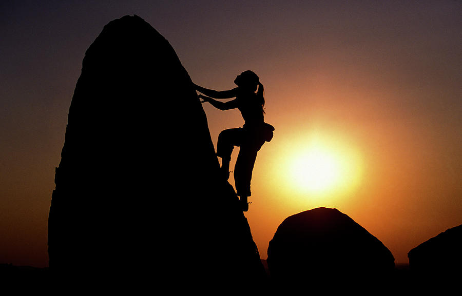 Nature Photograph - A Young Woman Bouldering At Sunset by Corey Rich