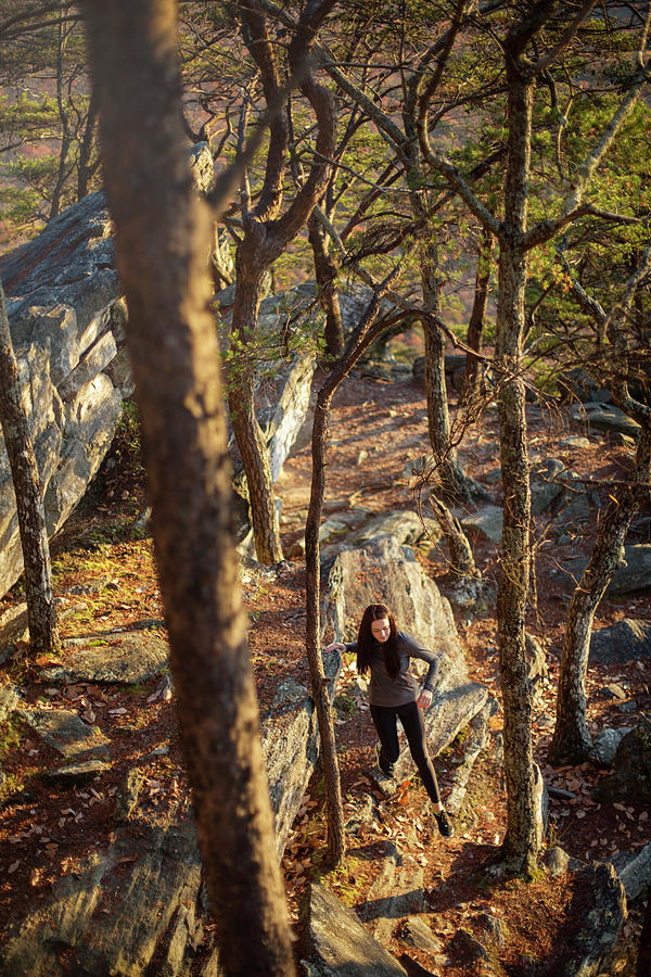 Nature Photograph - A Young Woman Hikes Down A Boulder by Corey Nolen