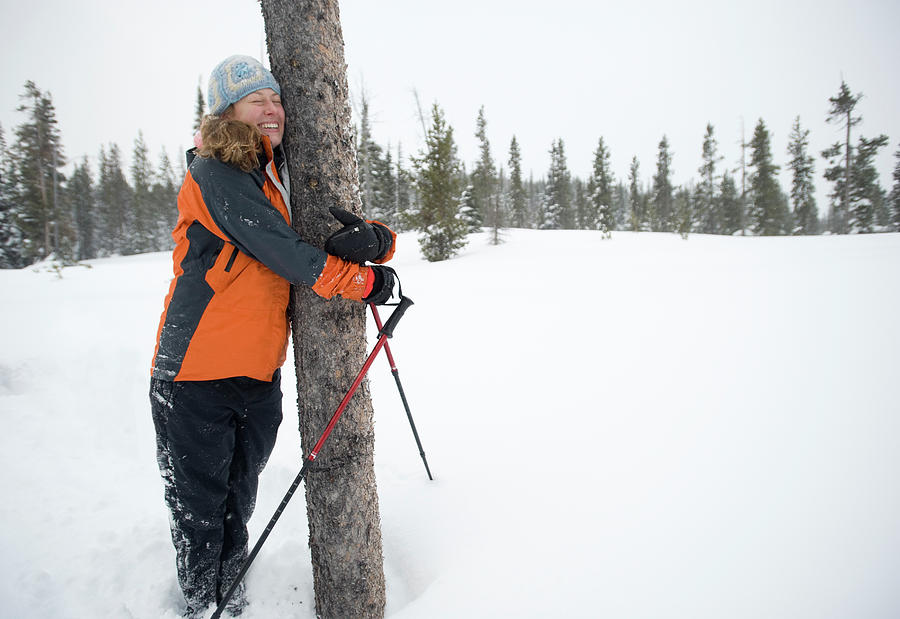 Bend Photograph - A Young Woman Hugs A Tree In A Snow by Jonathan Kingston