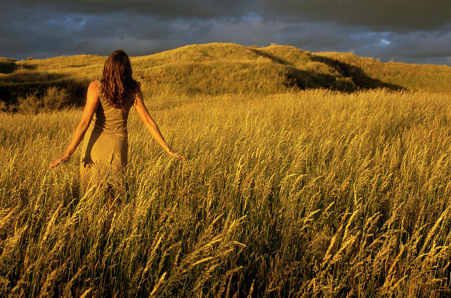Sunset Photograph - A Young Woman Runs Through A Field by Kyle George