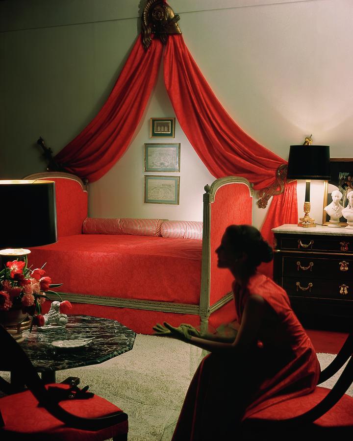 A Young Woman Sitting In A Red Bedroom Photograph by Horst P. Horst