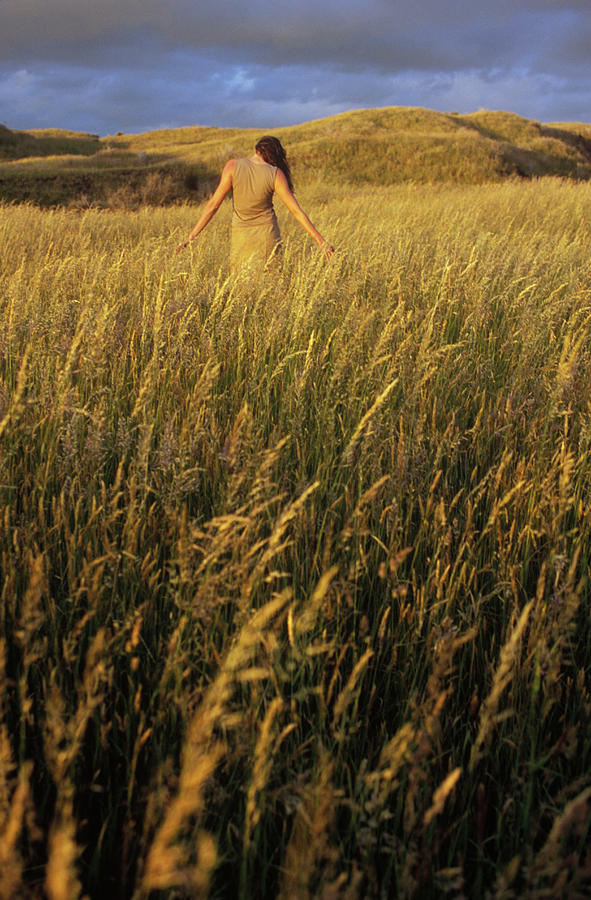 Sunset Photograph - A Young Woman Stretches In A Field by Kyle George