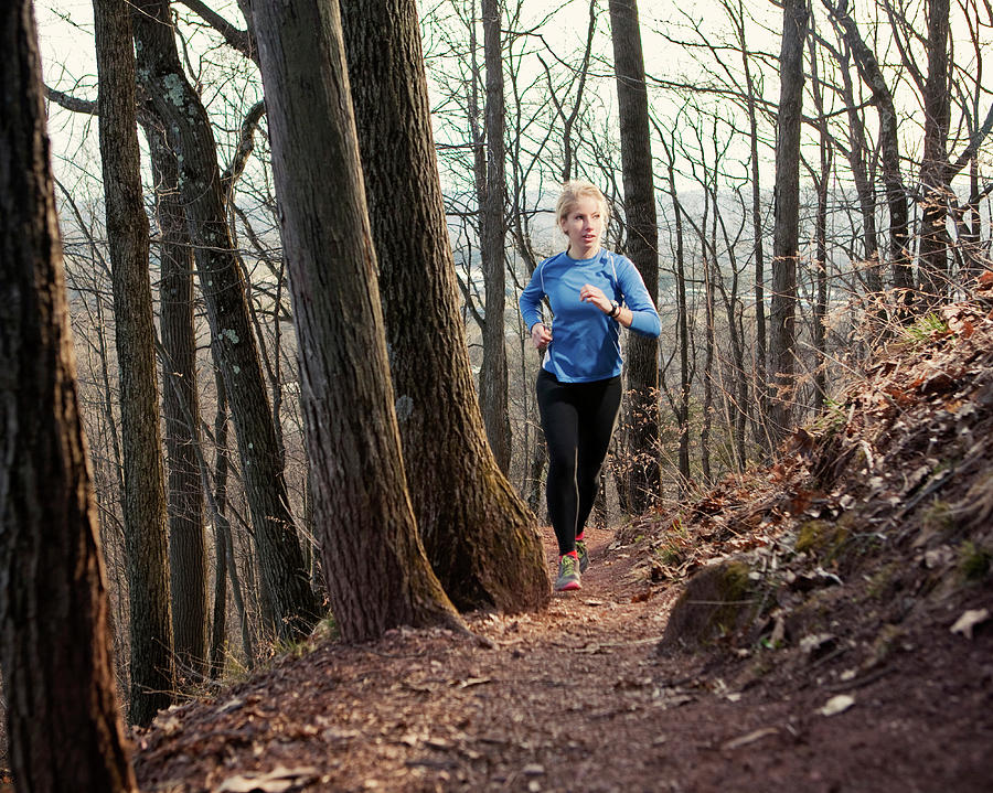 A Young Woman Trail Runs Along A Wooded Photograph by Chris Bennett ...