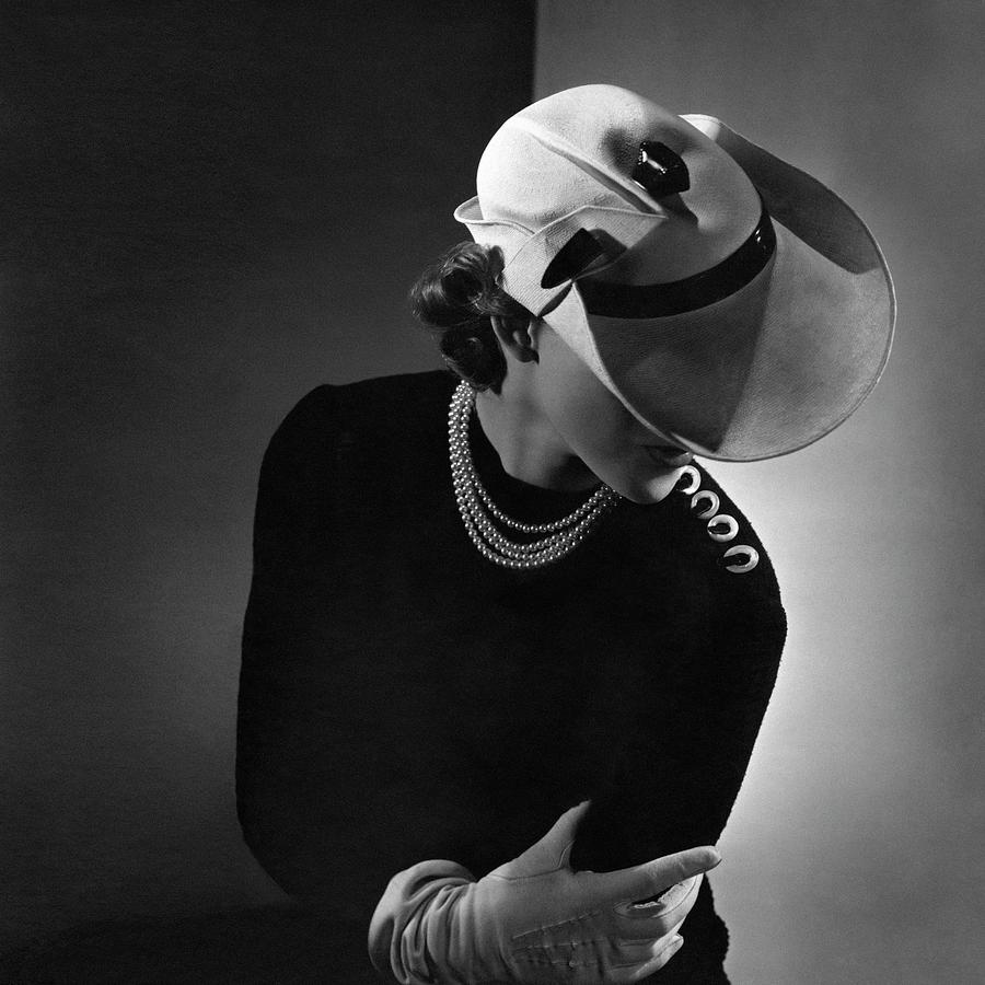 A Young Woman Wearing A White Hat And A Pearl Photograph by Horst P. Horst