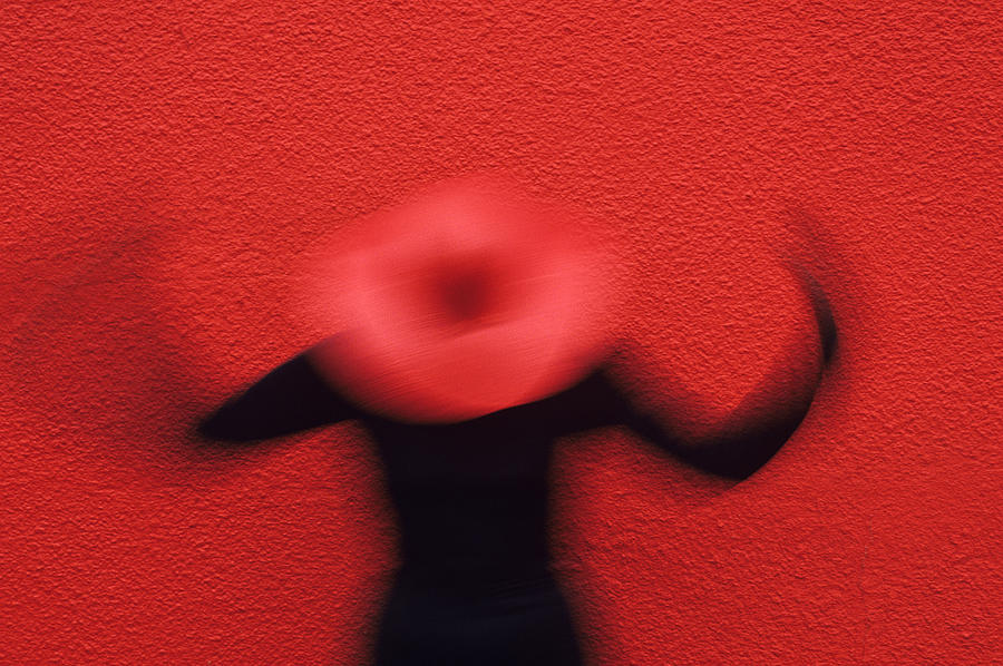 Woman motion red wall Photograph by Jim Corwin