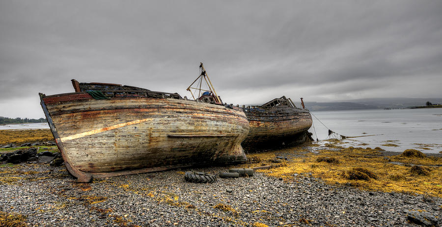 Colorful Abandoned boats on a seashore Photograph by Michalakis Ppalis