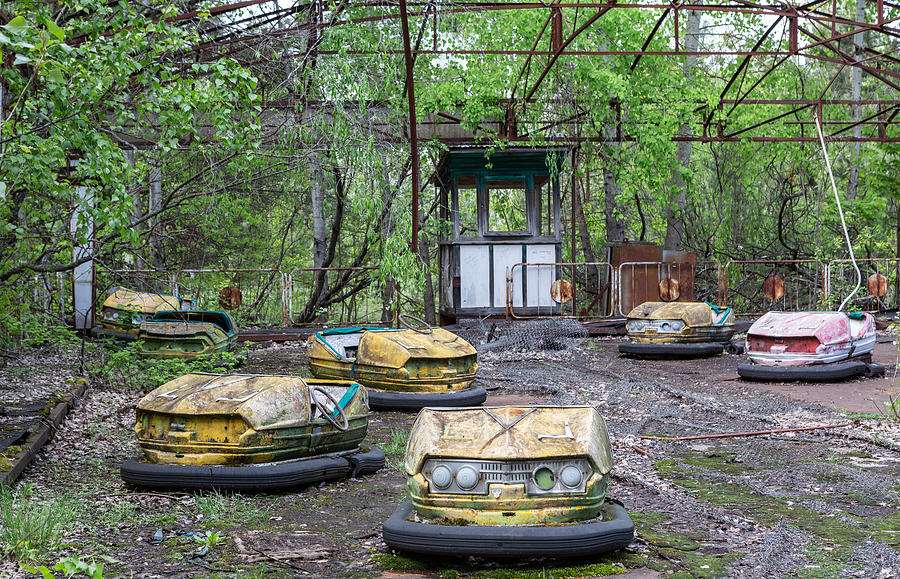Abandoned bumper cars in the amusement park of Pripyat City Photograph by Francisco Goncalves
