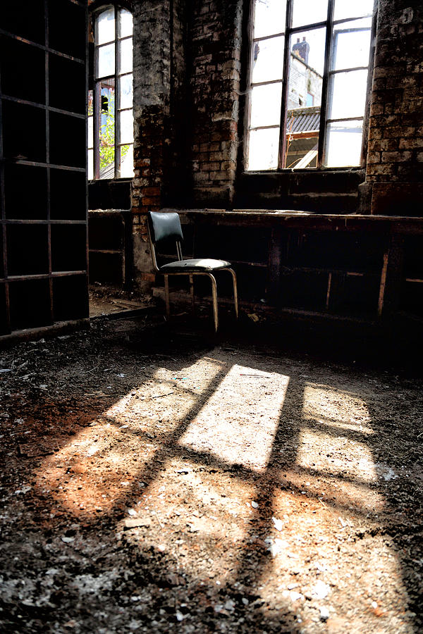 Architecture Photograph - Abandoned chair sits in sunlight by an abandoned window by Russ Dixon