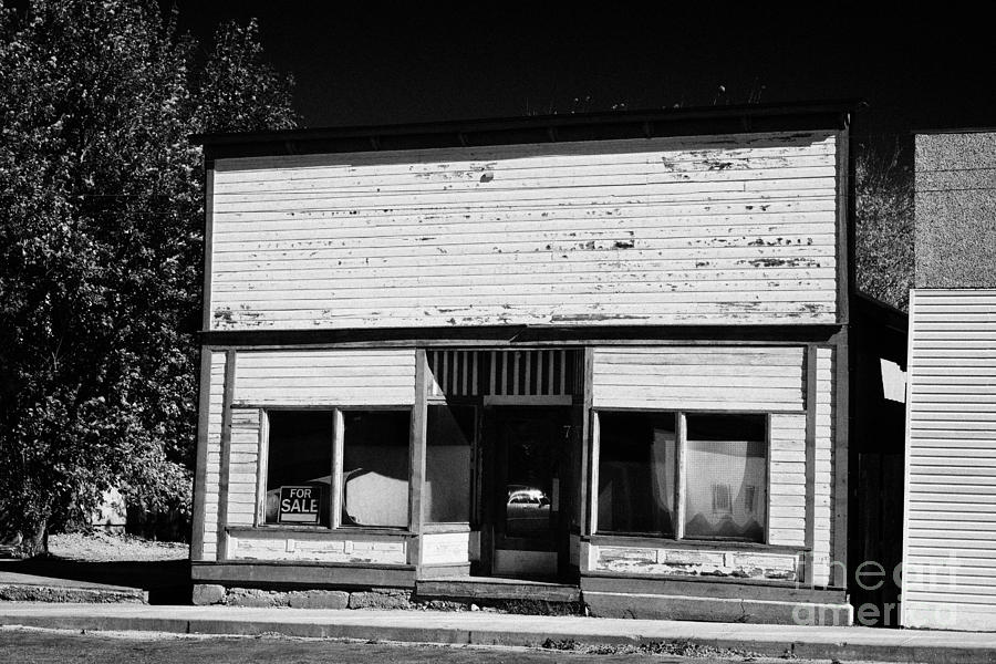 Architecture Photograph - abandoned old wooden facade shopfront hafford Saskatchewan Canada by Joe Fox