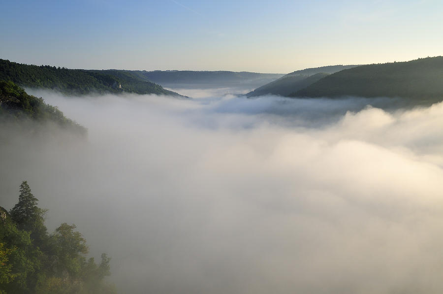 Above the clouds - morning mist in the valley Photograph by Matthias Hauser