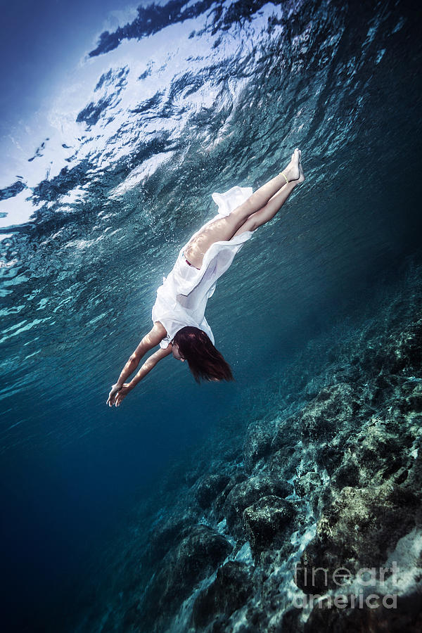 Active woman diving to the sea bottom Photograph by Anna Om