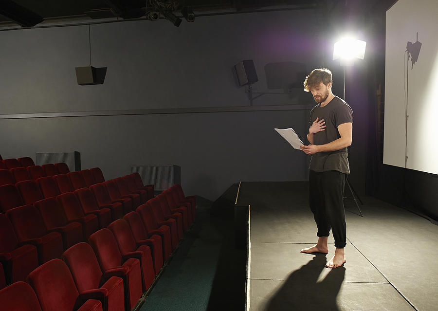 Actor rehearsing his lines on stage. Photograph by Dougal Waters