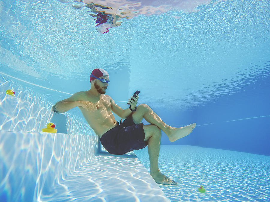 Addicted to social networking: with mobile phone underwater Photograph by Piola666