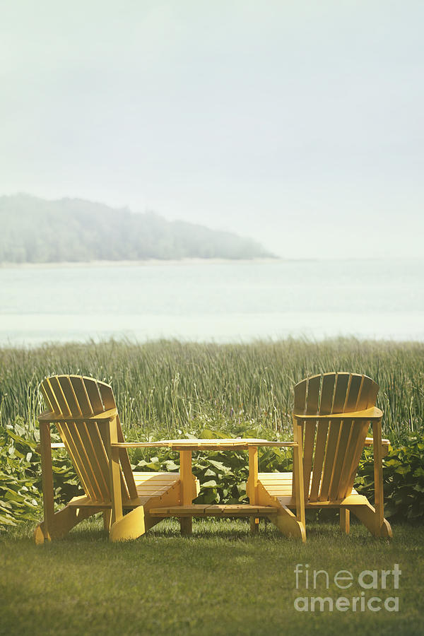 Adirondack chairs on the grass by the lake Photograph by Sandra Cunningham