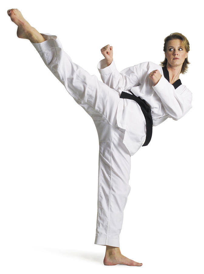 Adult Caucasian Female Martial Arts Expert In White With Blackbelt Performs Roundhouse Kick To Right Photograph by Photodisc