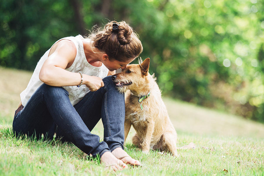 Adult Woman Enjoying Time with Pet Dog Photograph by RyanJLane