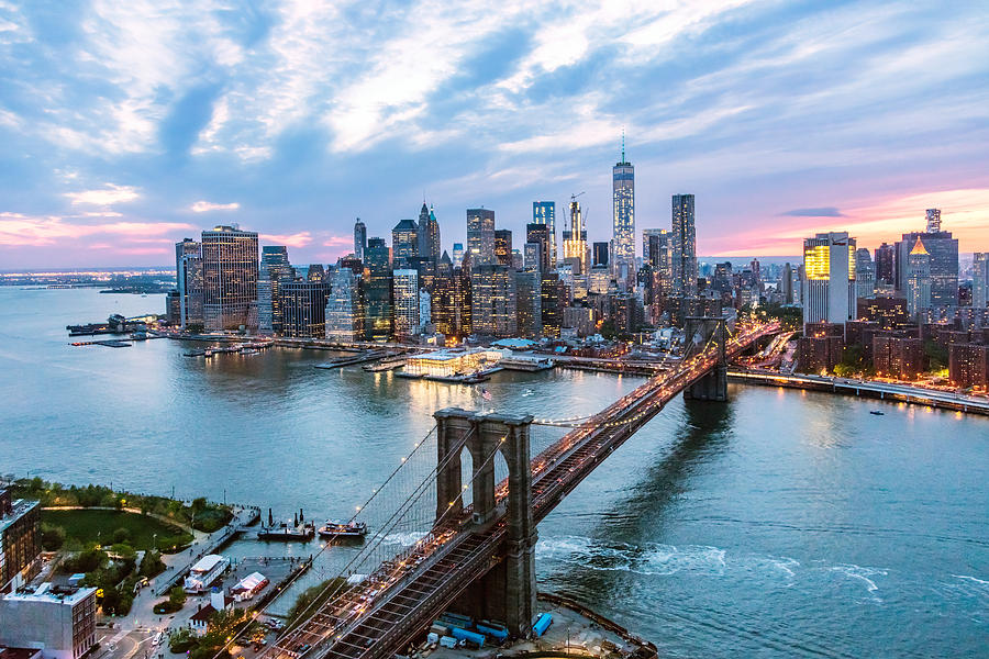 Aerial of New York city and Brooklyn bridge at dusk Photograph by Matteo Colombo