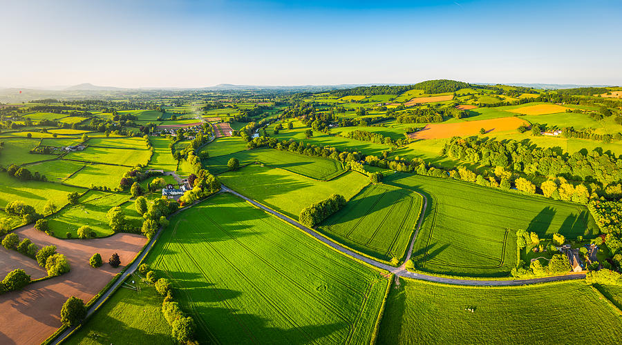 Aerial panorama over idyllic green summer farm fields crops pasture Photograph by fotoVoyager