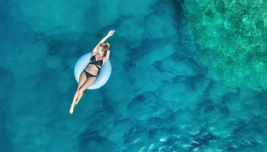 Aerial view at the girl on sea. Turquoise water from air as a background from air. Natural seascape at the summer time. Seascape from drone Photograph by Biletskiy_Evgeniy