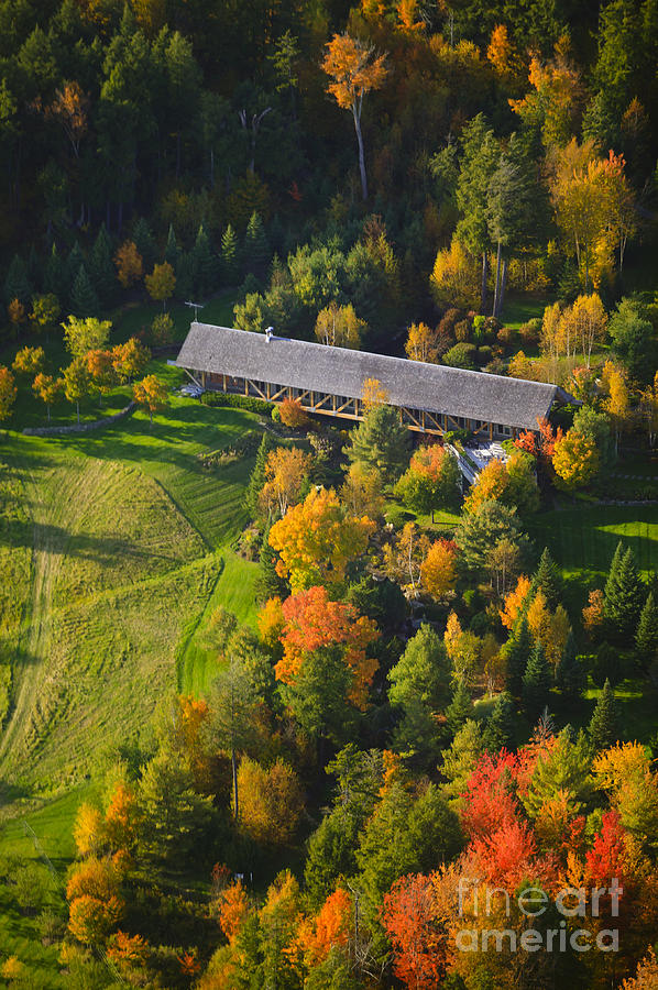 Aerial view of fall foliage and a covered bridge Photograph by Don Landwehrle