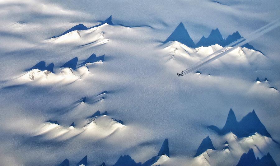 Aerial view of US Air Force C-17 flying over mountains and glaciers of Victoria Land, Antarctica Photograph by copyright Jeff Miller