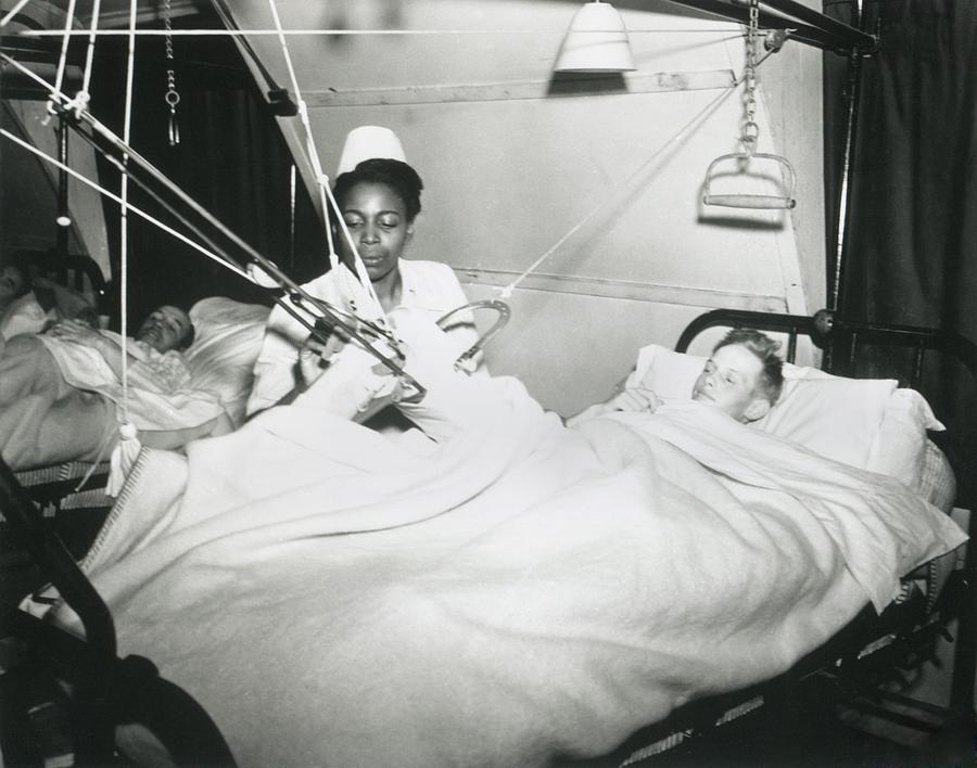 African America U.s. Army Nurse Treats Photograph by Everett