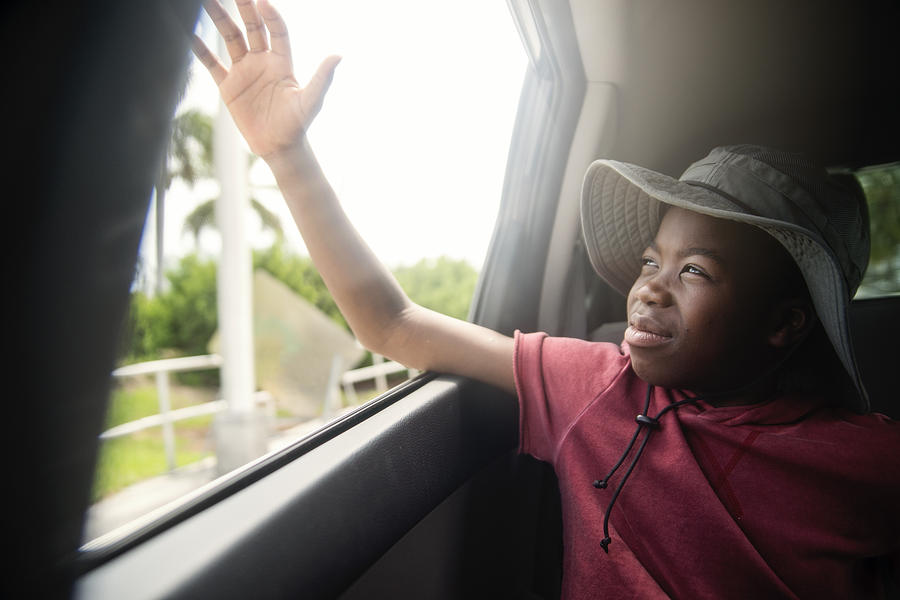 African-american boy on the back seat of a car. Photograph by Martinedoucet